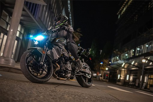 Front angle low down of a person riding a motorcycle on the street. opens in a new window