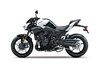 Side angle of a motorcycle with white accents staged in a white studio background.