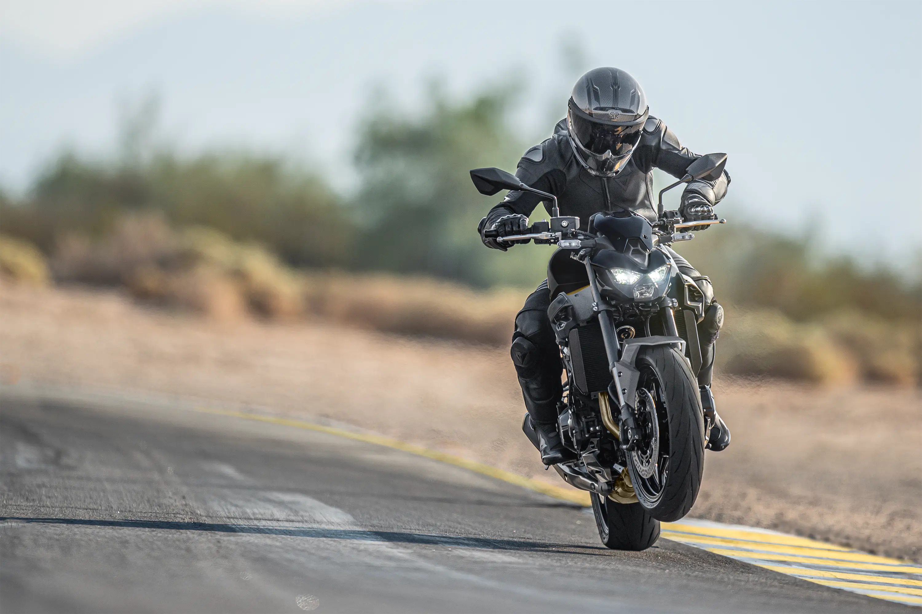 Front angle of a person riding a motorcycle on a highway.