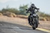 Front angle of a person riding a motorcycle on a highway.