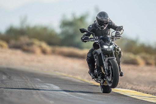 Front angle of a person riding a motorcycle on a highway. opens in a new window