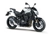 Three-quarter front angle of a motorcycle with white accents staged in a white studio background.