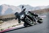 Three-quarter front angle of a person riding a motorcycle on a track.
