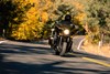 Front angle of a person riding a motorcycle on a highway.