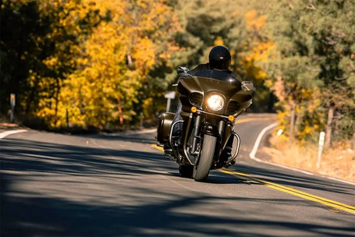 Front angle of a person riding a motorcycle on a highway. opens in a new window