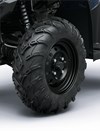 Closeup detail of wheels on an ATV staged in a white studio background.