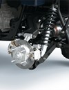 Closeup detail of brakes on an ATV staged in a white studio background.