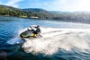 Profile angle of a person on a personal watercraft on the water.