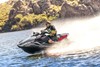 Profile angle of a person on a personal watercraft on the water.