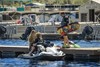 Front angle of a personal watercraft parked on the water.