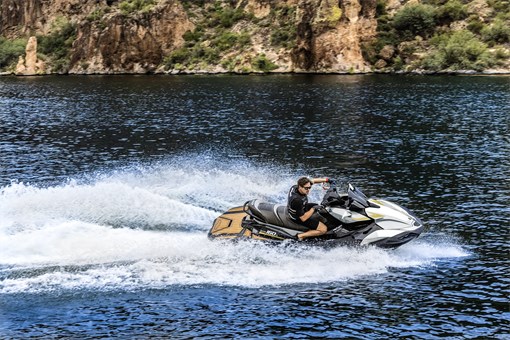 Side angle of a person on a personal watercraft on the water. opens in a new window