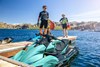 Front angle of a personal watercraft parked on the water.