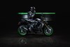 Side angle of a motorcycle parked in a black studio background.