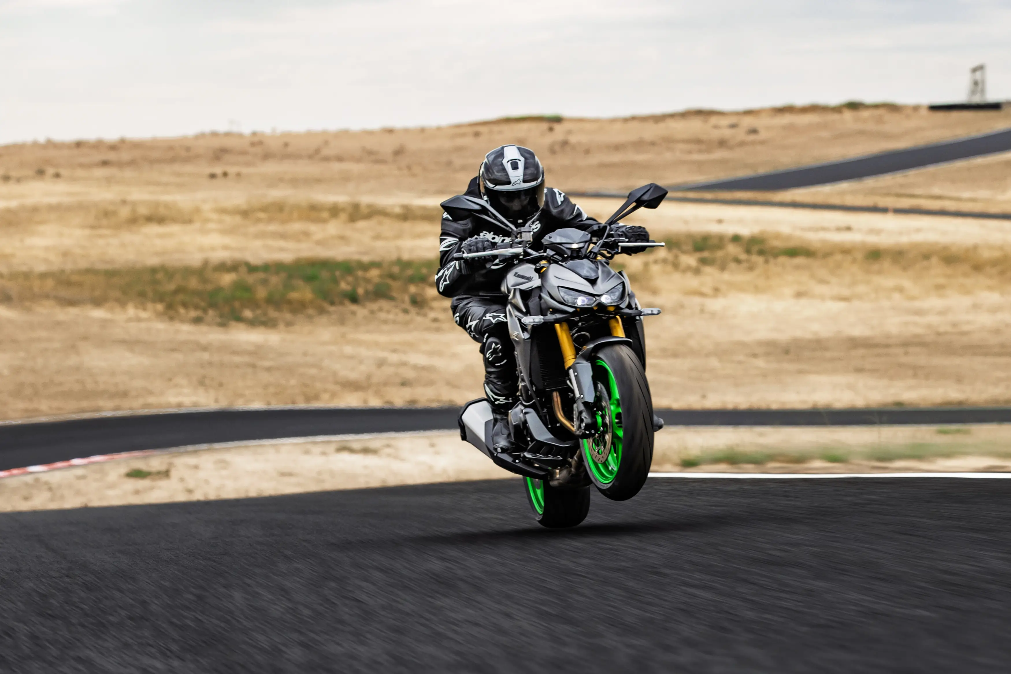 Front angle of a person riding a motorcycle on a track.