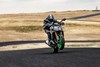 Front angle of a person riding a motorcycle on a track.