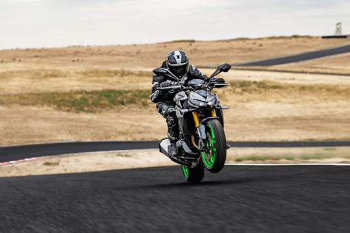Front angle of a person riding a motorcycle on a track. opens in a new window
