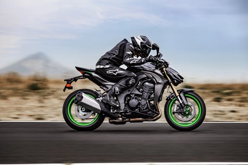 Side angle of a person riding a motorcycle on a track. opens in a new window