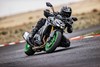 Three-quarter front angle of a person riding a motorcycle through a corner on a track.