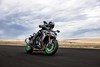 Three-quarter front angle of a person riding a motorcycle on a track.