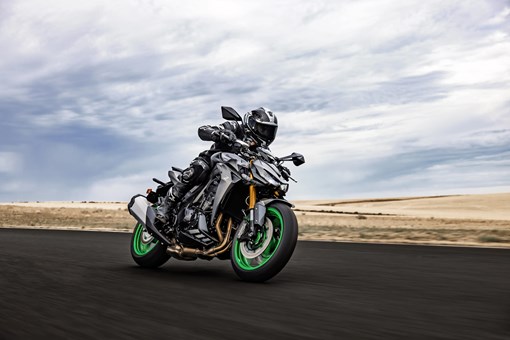 Three-quarter front angle of a person riding a motorcycle on a track. opens in a new window