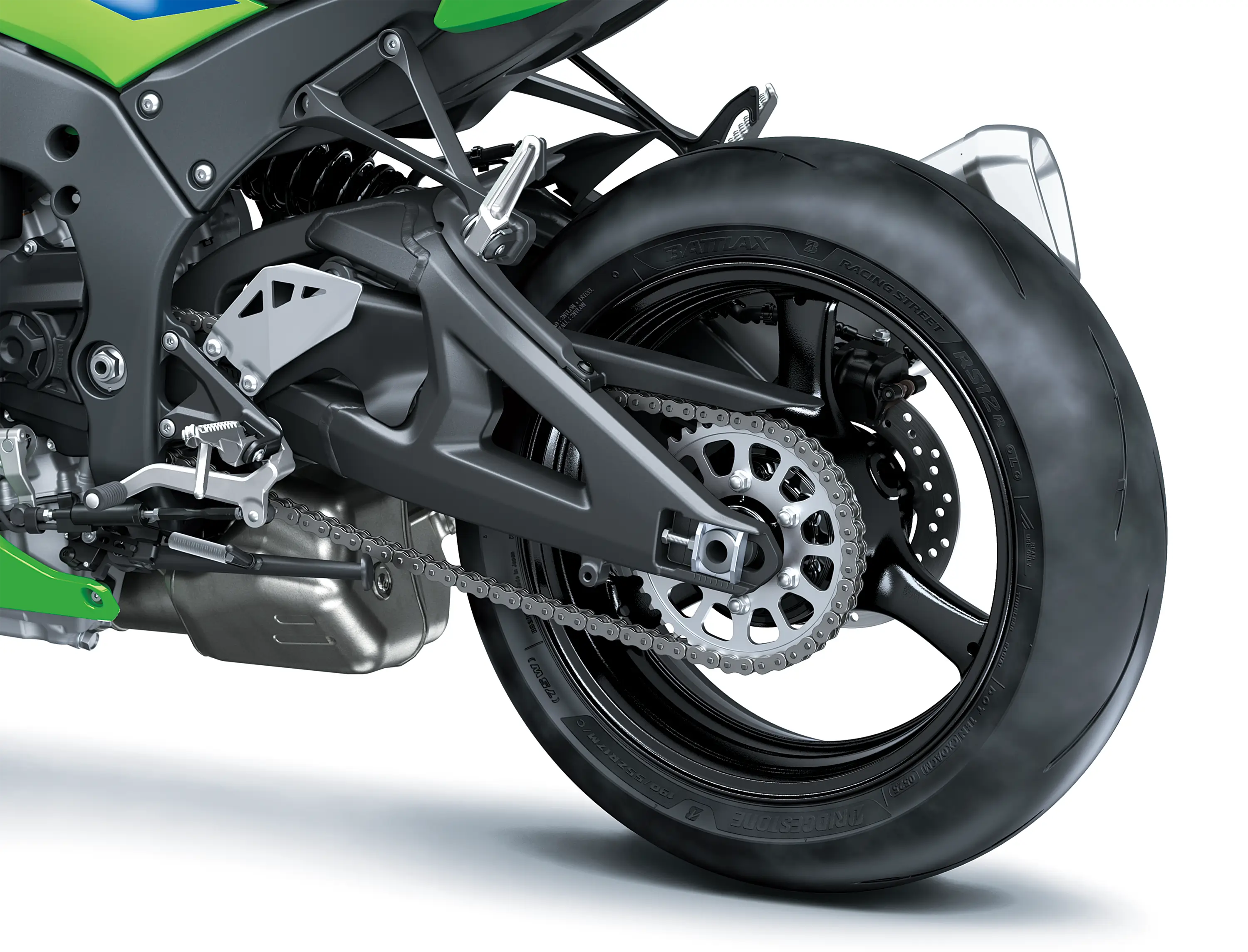 Close-up of the rear tire of a motorcycle staged in a white studio background.