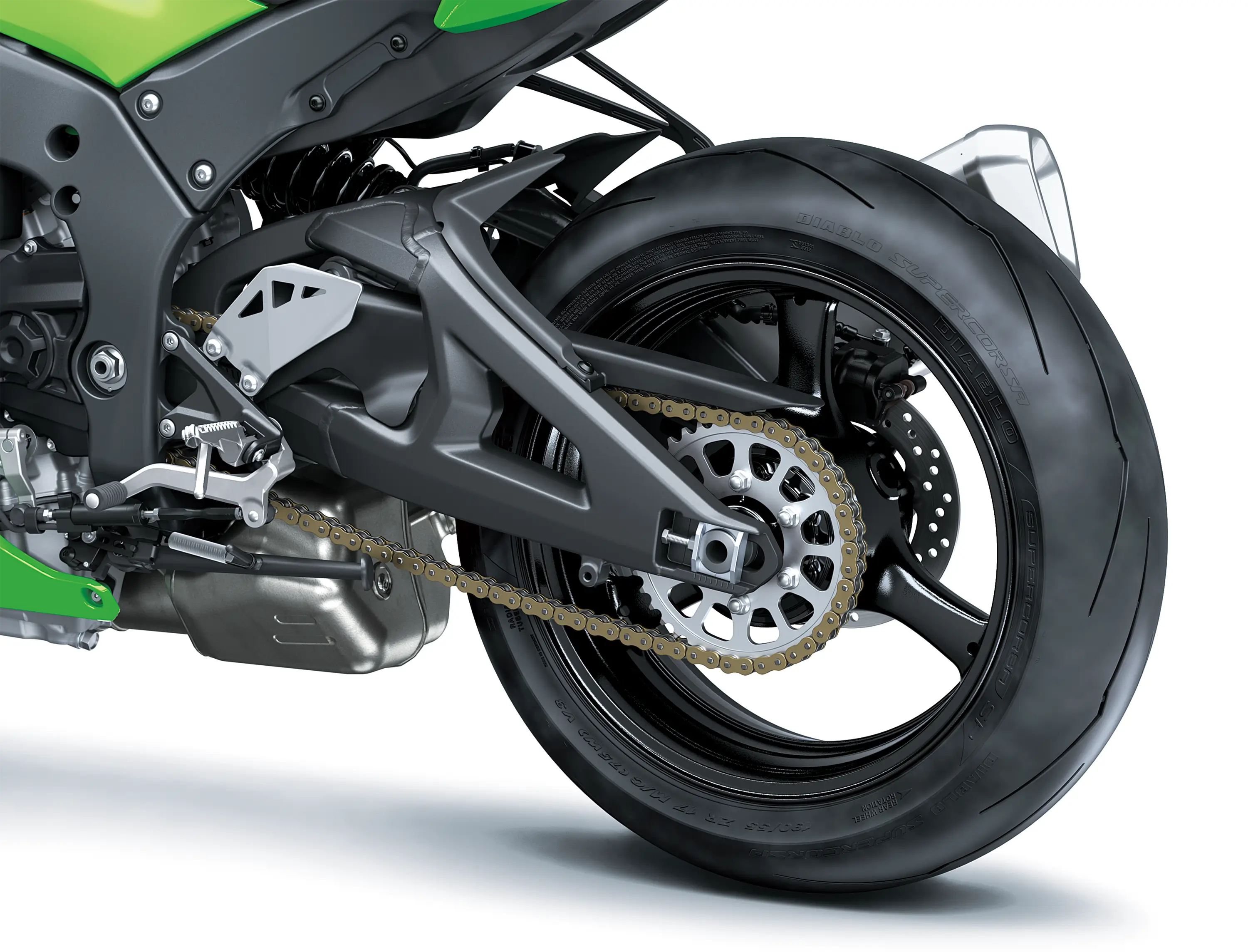 Close-up of the rear tire of a motorcycle staged in a white studio background.