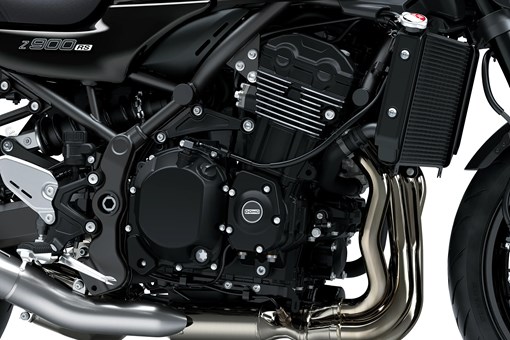 Close-up of the right-side of the engine bay of a motorcycle staged in a white studio background. opens in a new window