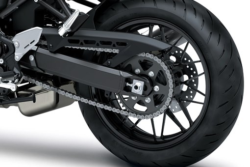 Close-up of the rear tire of a motorcycle staged in a white studio background. opens in a new window