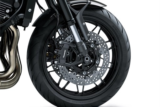 Close-up of the front tire of a motorcycle staged in a white studio background. opens in a new window