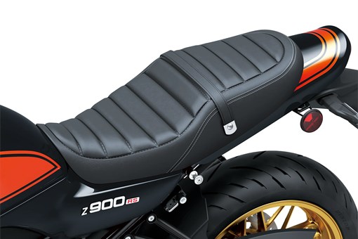 Close-up of the seat of a motorcycle staged in a white studio background. opens in a new window