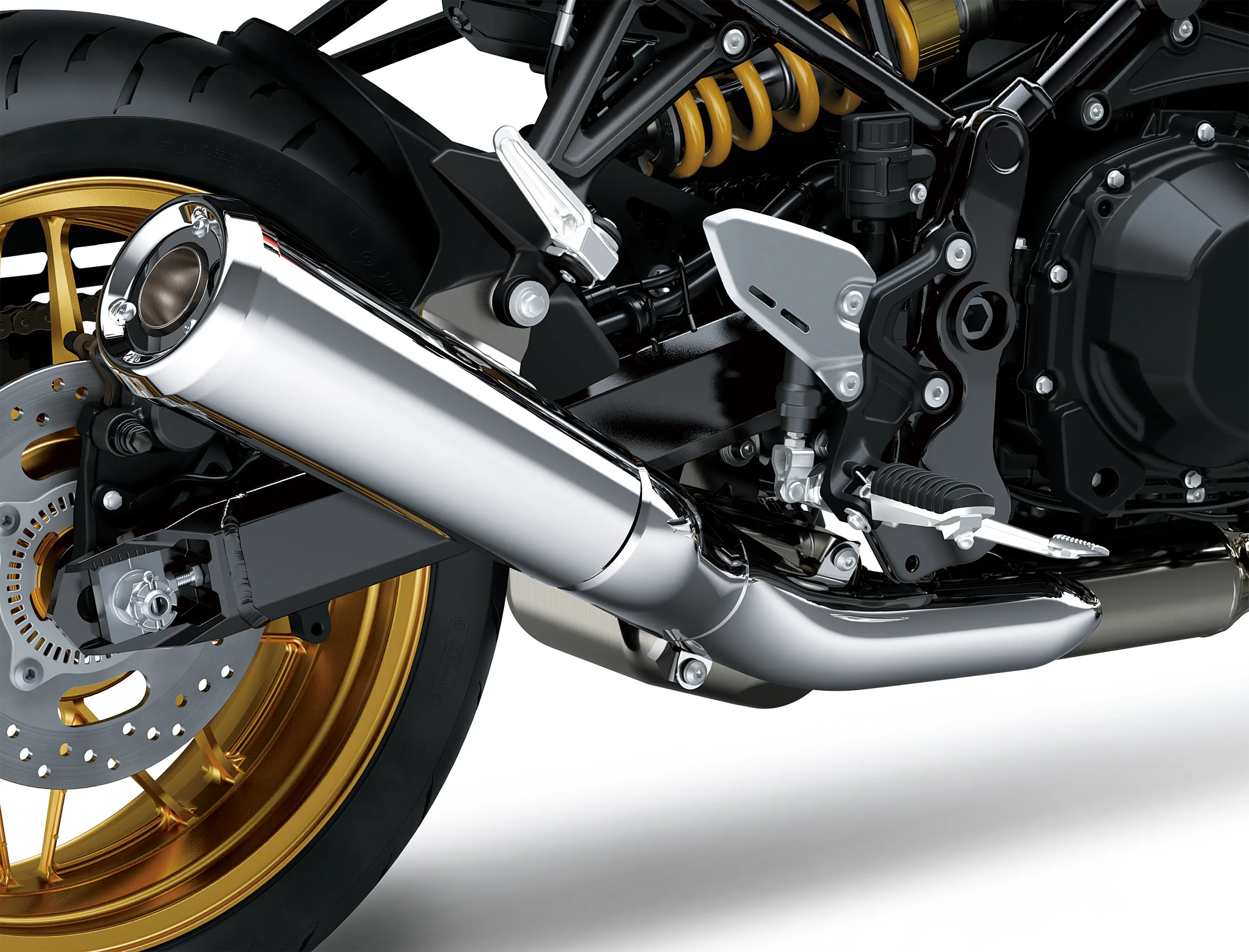 Close-up of the exhaust of a motorcycle staged in a white studio background.