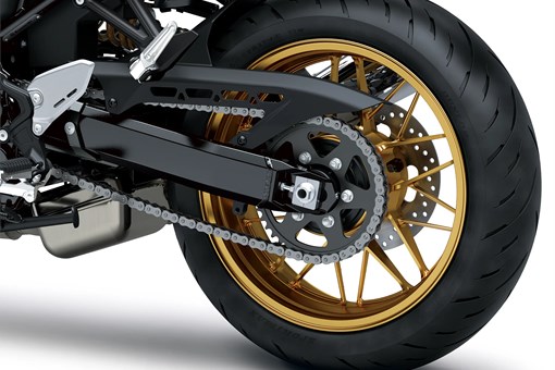 Close-up of the rear tire of a motorcycle staged in a white studio background. opens in a new window
