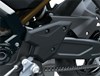 Chain of a motorcycle staged in a white studio background.