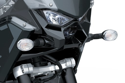 Front close in on headlights of a motorcycle staged in a white studio background. opens in a new window