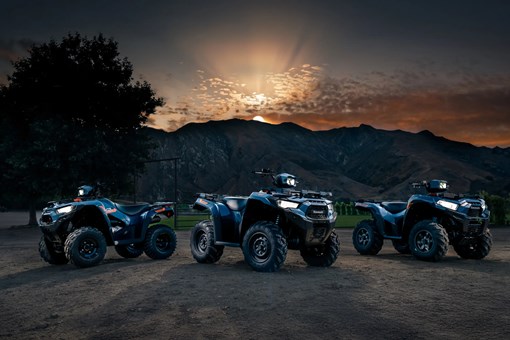 Three ATVs staged in front of a mountain. opens in a new window