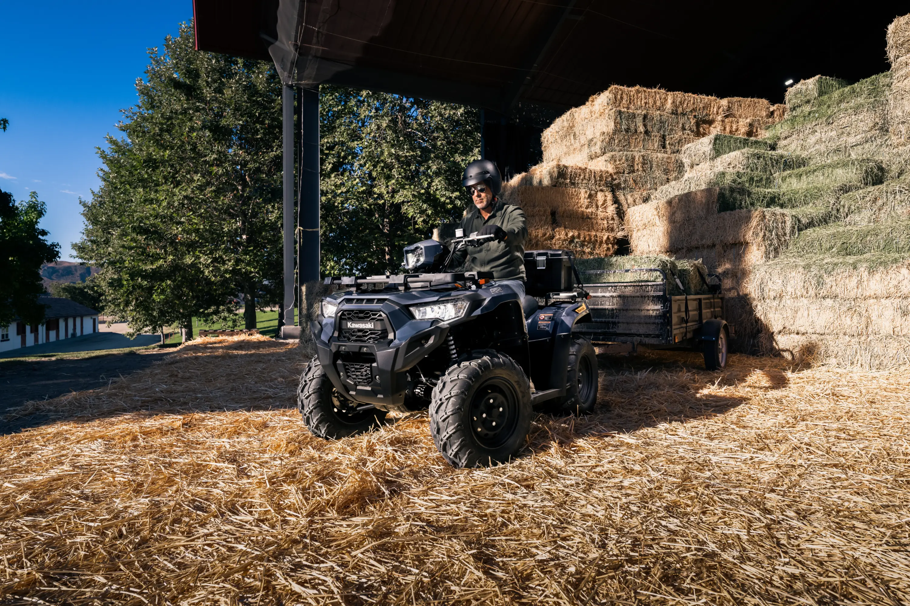 Three-quarter front angle of a person towing a trailer with an ATV.