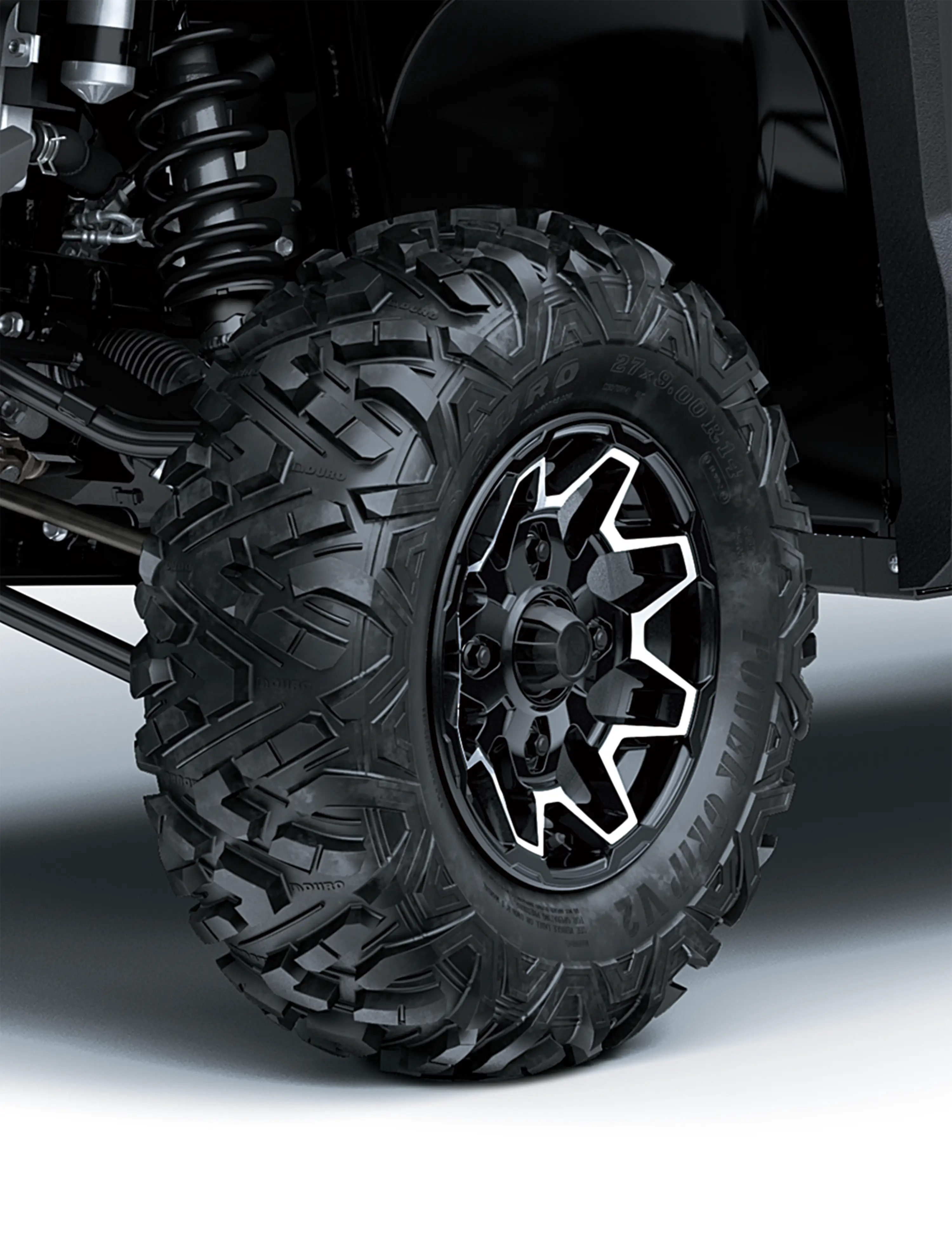 Close-up of a tire of a side x side in a white studio background.