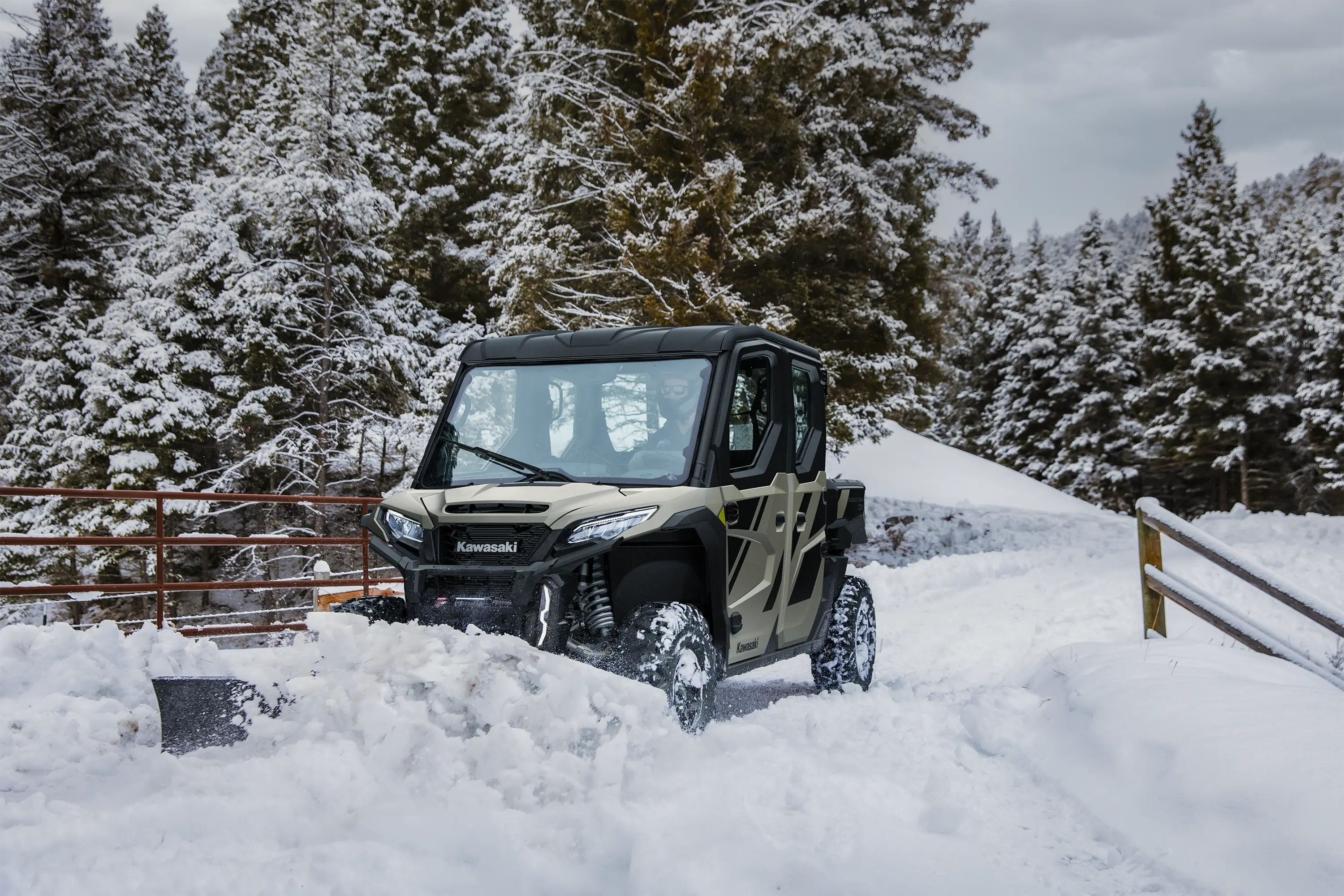 Front angle of a person plowing snow with their side x side.