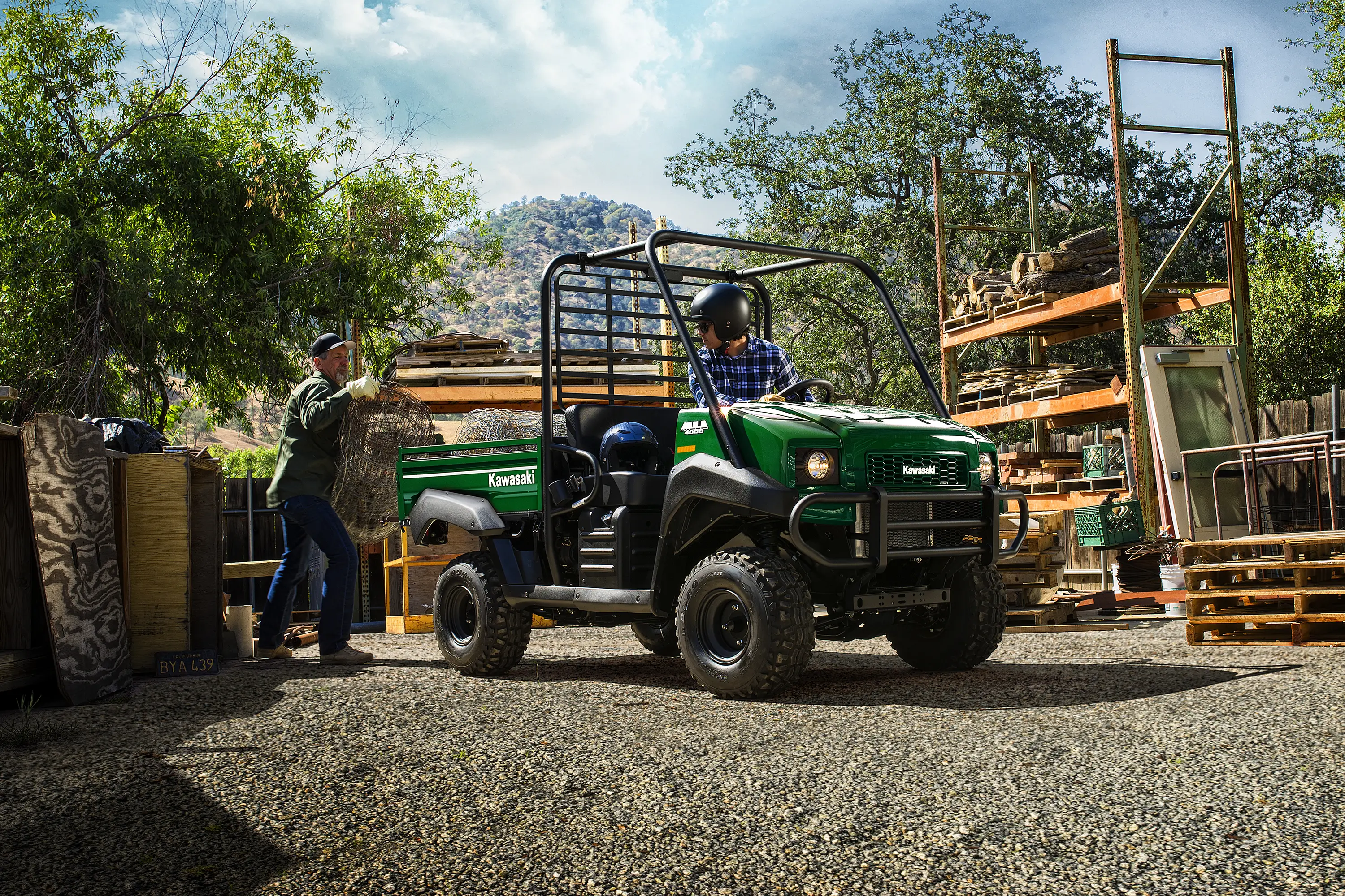 Three-quarter front angle of a green side x side parked on a jobsite.