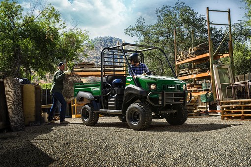 Three-quarter front angle of a green side x side parked on a jobsite. opens in a new window