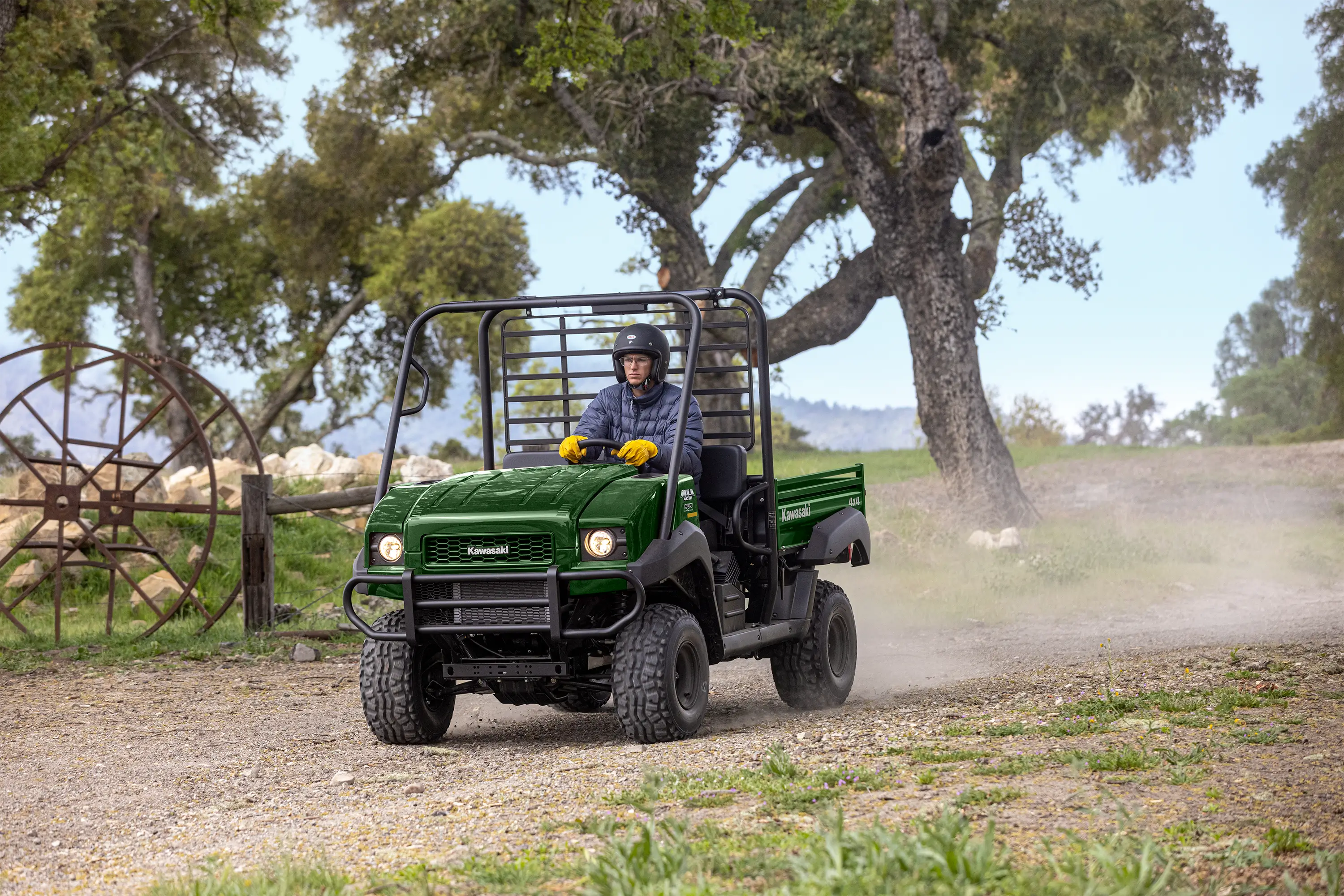 Front angle of a person driving a side x side at a ranch.
