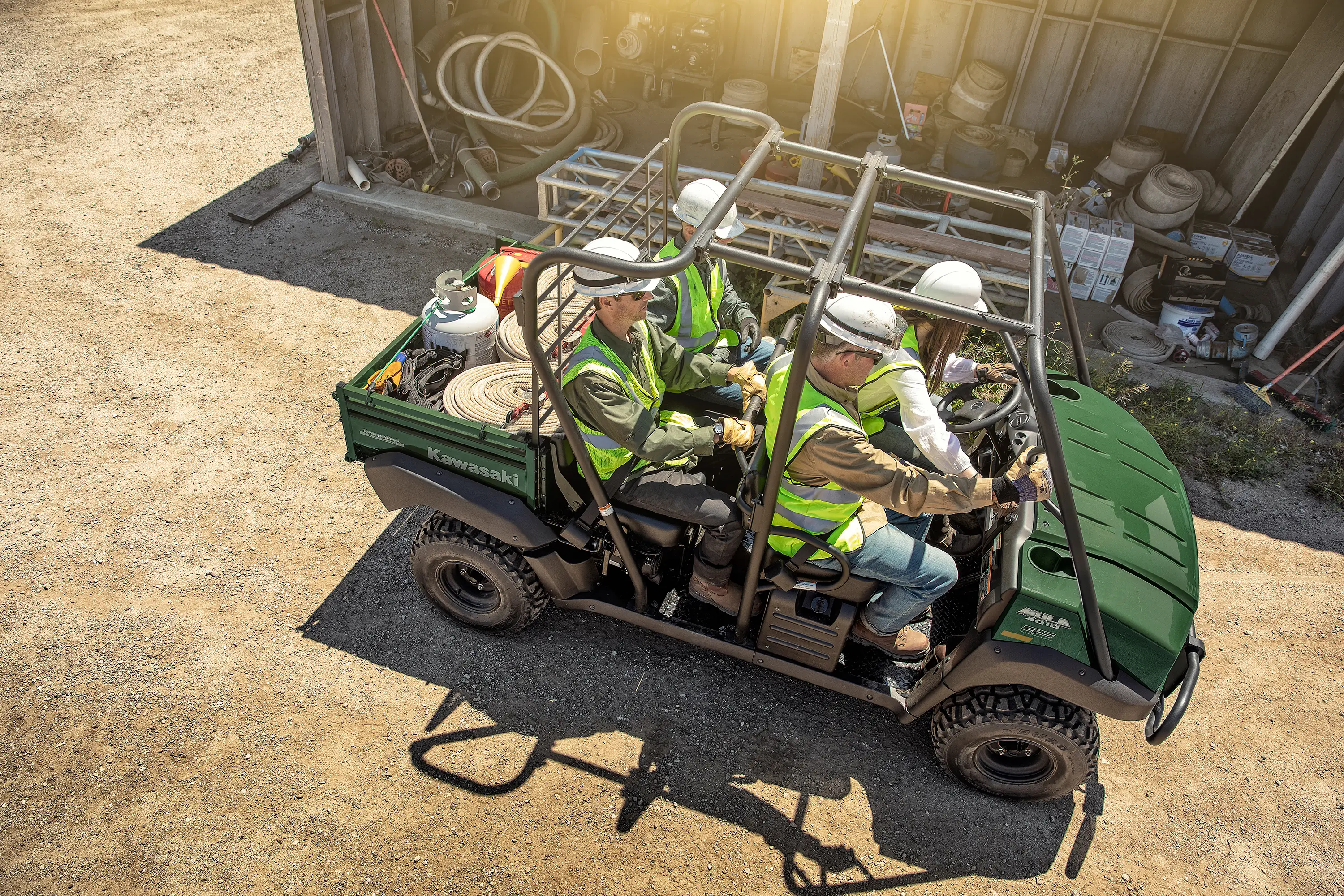 Aerial view of four people driving a side x side off-road.