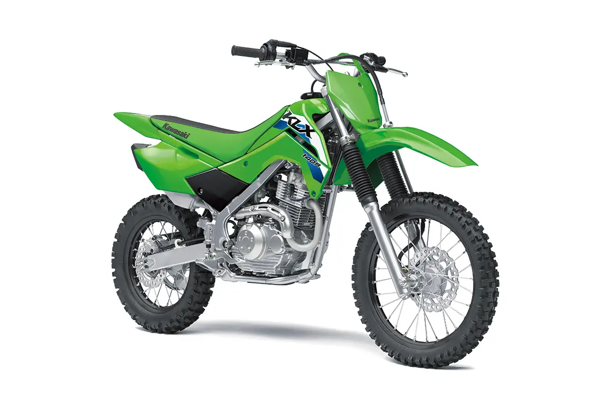 Front three-quarter view of a green youth dirt bike in a white studio background.