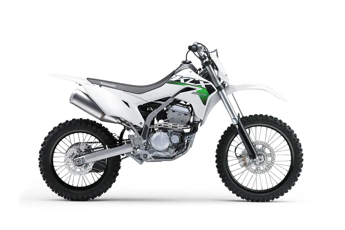 Right side view of a white dirt bike staged in a white studio background.