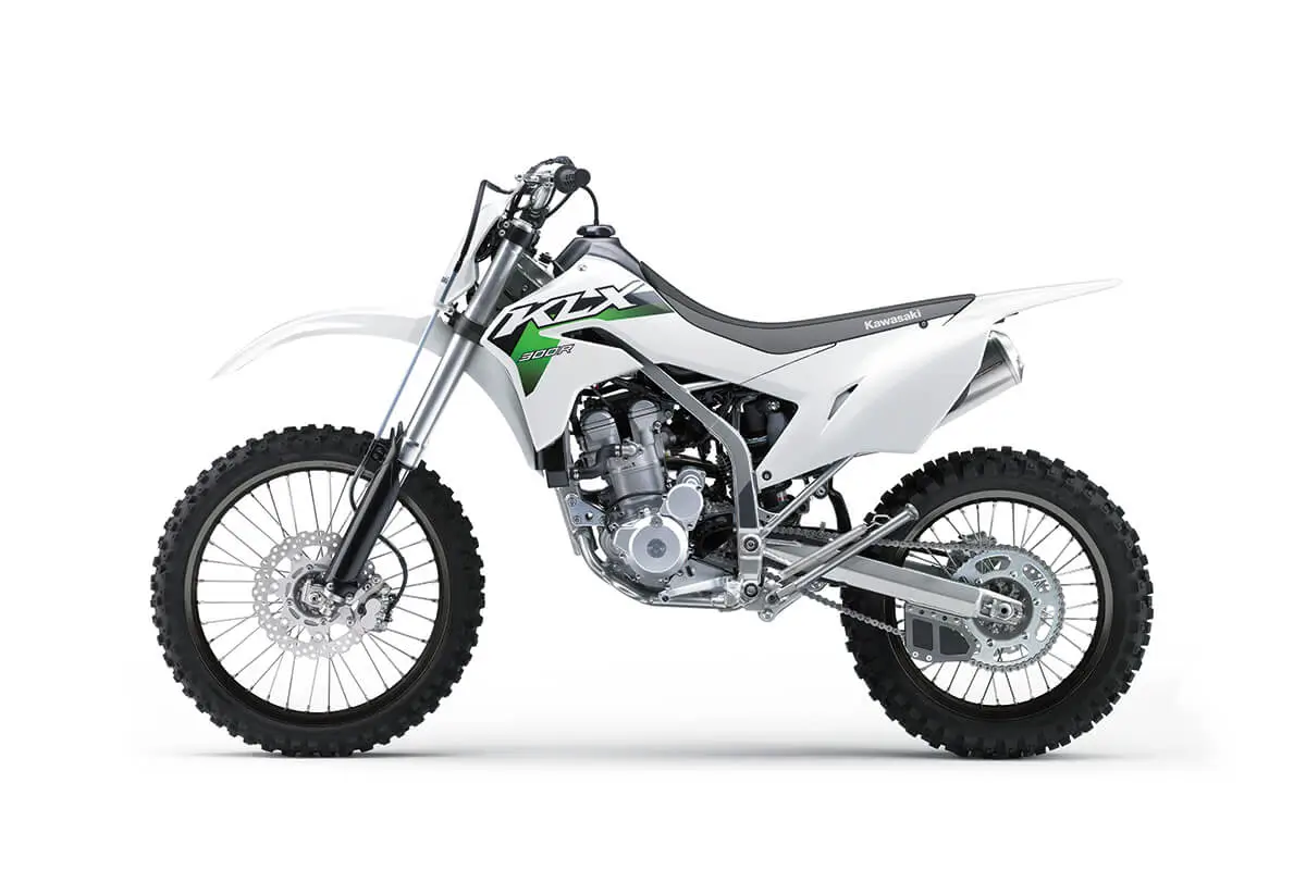 Left side view of a white dirt bike staged in a white studio background.