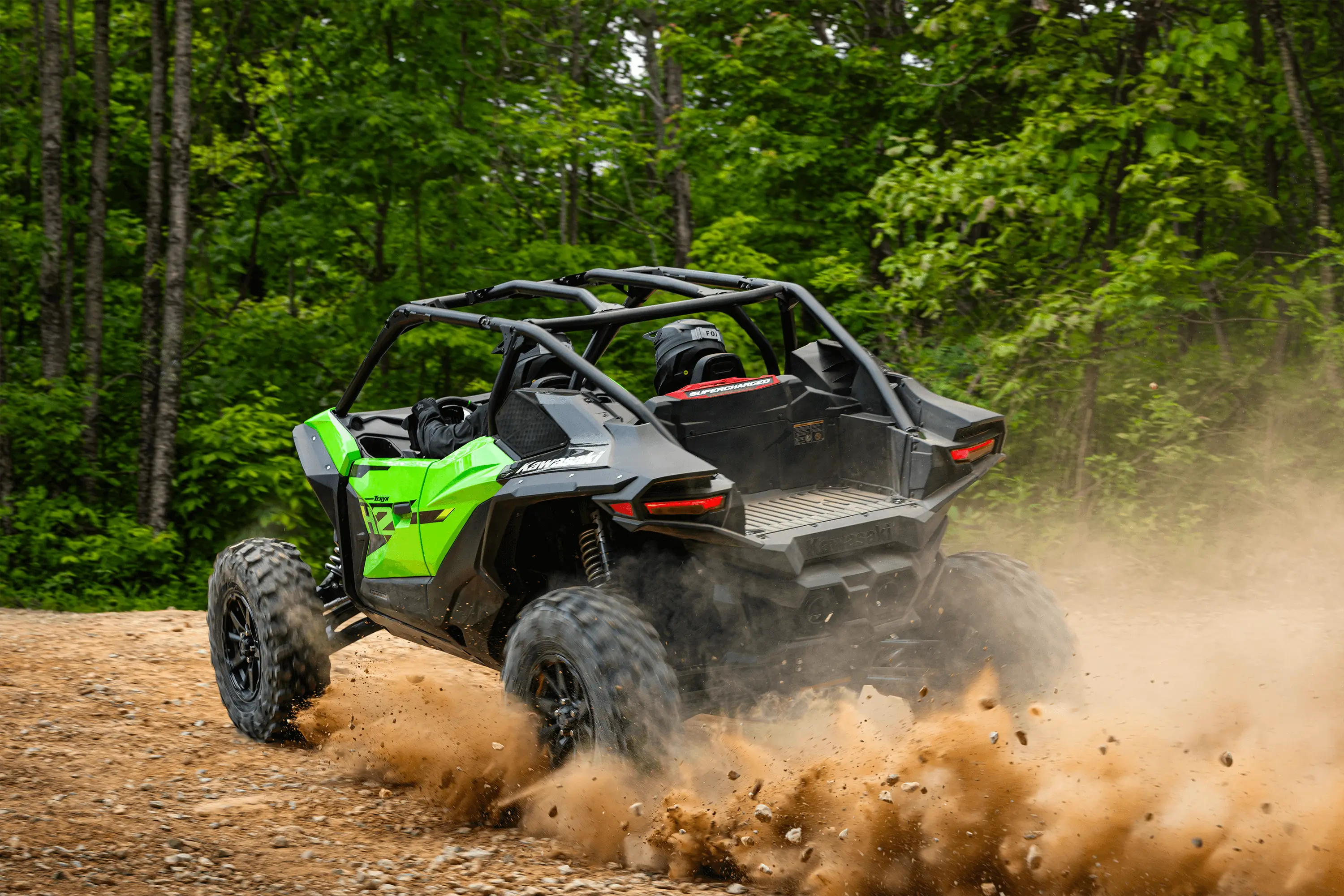 Three-quarter rear angle of a person driving a side x side off-road.