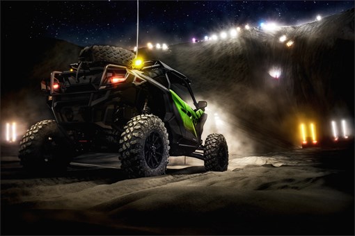 Three-quarter rear angle of a side x side parked off-road. opens in a new window