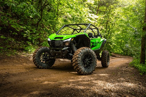 Three-quarter front angle of a side x side parked off-road. opens in a new window