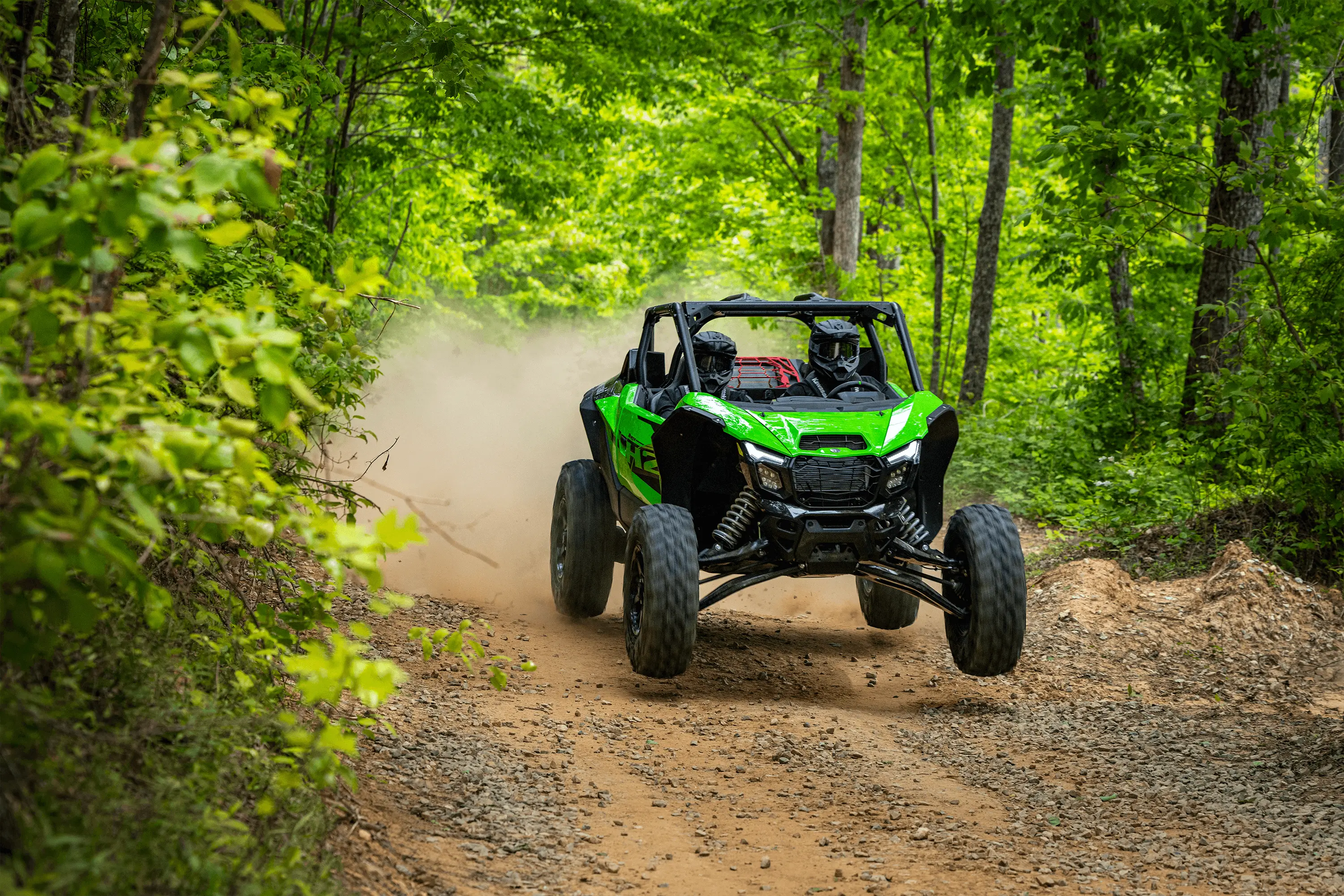 Three-quarter front angle of a person jumping a side x side off-road.