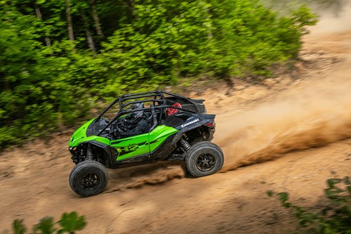 Overhead side angle of a person driving a side x side off-road. opens in a new window